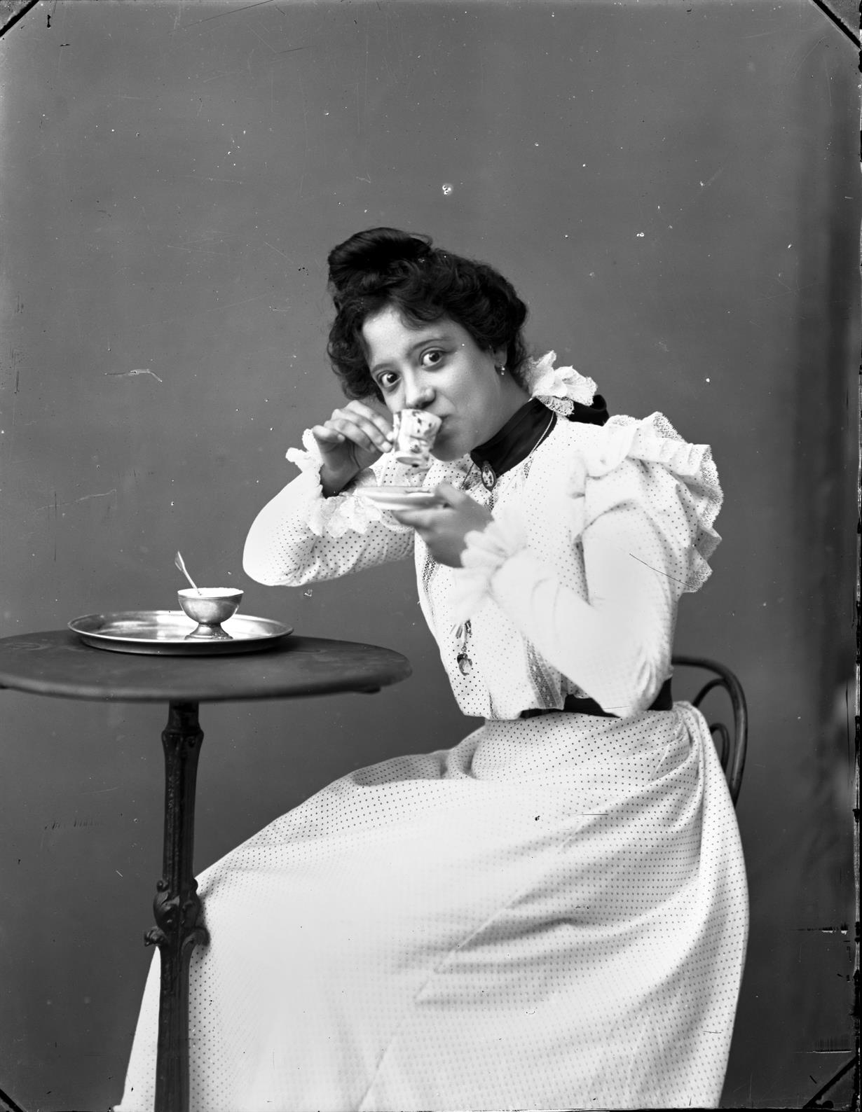 Mulher tomando café : retrato de estúdio
